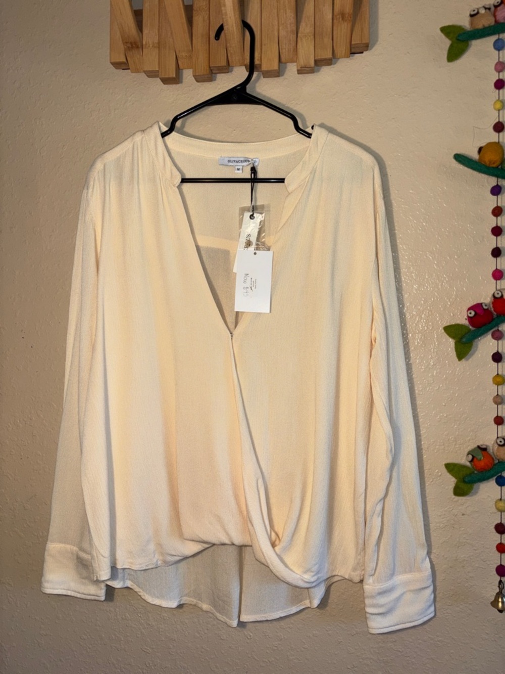 NWT Olivaceous brand women's blouse, featuring a V-neck and wrap-style front